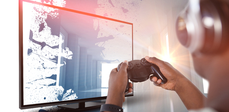 Man playing video game against white background against digitally generated roomの写真素材