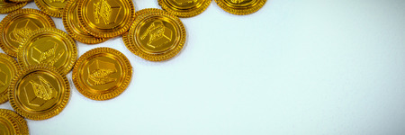 High angle view of St Patricks Day gold coin chocolates on white backgroundの写真素材