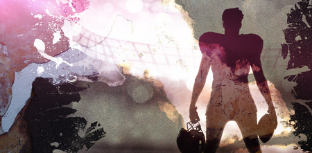 Rusty weathered wall against silhouette of american football playerの写真素材