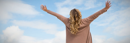 Rear view of a woman stretching  against forest and fieldsの写真素材