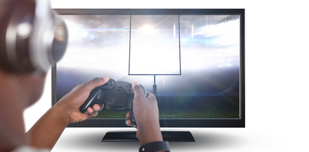 Man playing video game against white background against close-up of blank computer monitorの写真素材