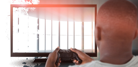 Man playing video game against white background against abstract roomの写真素材