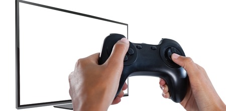 Woman playing video game against white background against blank computer monitor