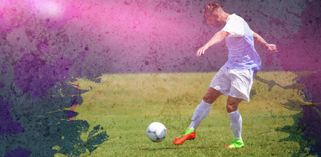 Male soccer player playing football against dirty old wall backgroundの写真素材
