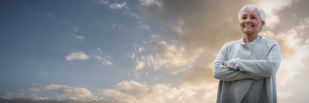Portrait of retired women  against cloudy sky landscapeの写真素材