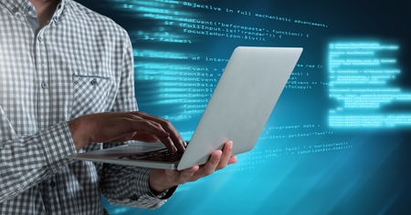 Digital composite of Man typing coding text on laptop