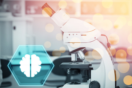 Brain against microscope in laboratory
