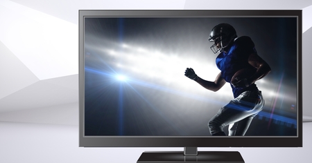 Digital composite of american football player on televisionの写真素材