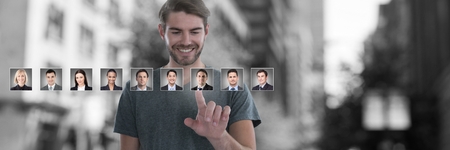 Digital composite of Man touching portrait profiles of different peopleの写真素材
