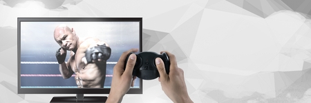 Digital composite of Hands holding gaming controller  with mixed martial arts fighter on television