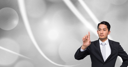 Digital composite of Man touching air with sparklesの写真素材