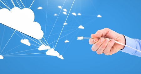 Digital composite of Hand holding wire connection with cloudsの写真素材