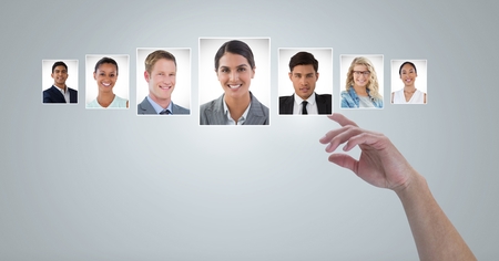 Digital composite of Hand touching portrait profiles of different peopleの写真素材