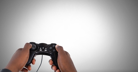Digital composite of Hands holding gaming controller