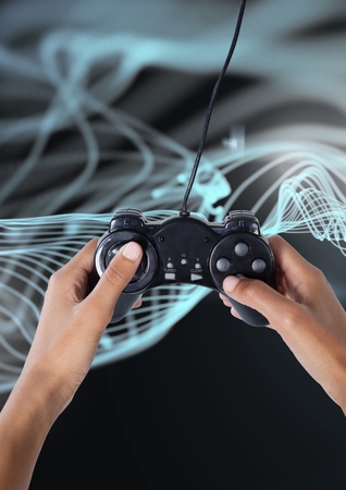 Digital composite of Hands holding gaming controllerの写真素材