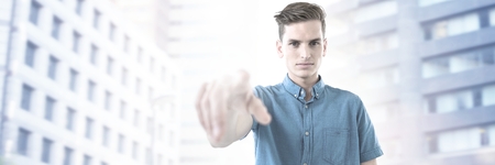 Digital composite of Man touching air in city