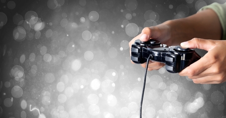 Digital composite of Hands holding gaming controller