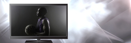 Digital composite of basketball on televisionの写真素材