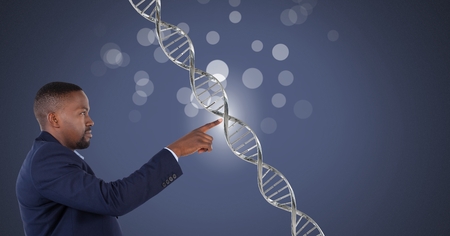 Digital composite of man touching genetic DNA and sparklesの写真素材