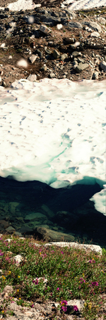 Snow falling against frozen glacier on rockの写真素材