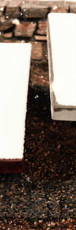 Snow falling against bench and table covered with snowの写真素材