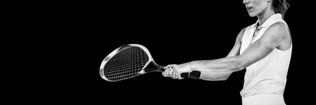 Athlete playing tennis with a racket on white backgroundの写真素材