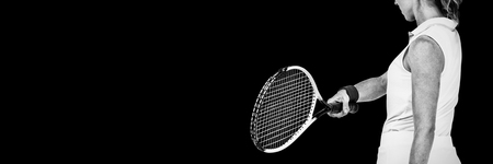 Athlete playing tennis with a racket on white background