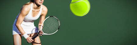 Tennis woman against green backgroundの写真素材