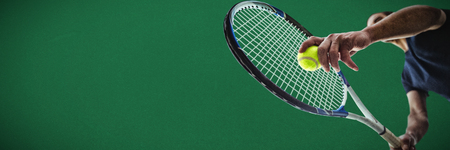 Tennisman against green backgroundの写真素材