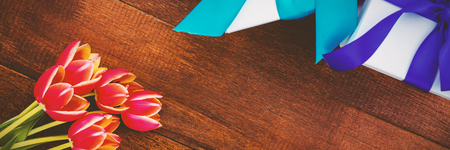 Colorful flowers and gift on wooden floorの写真素材