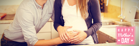 mothers day greeting against young happy pregnant woman with husband
