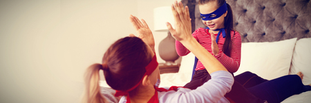 Mother and daughter playing superwoman