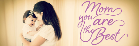 Mothers Day message against happy mother carrying cute baby girlの写真素材