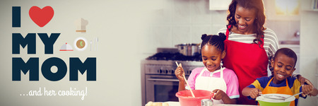 mothers day greeting against children preparing cake with motherの写真素材