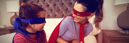 Mother and daughter playing super heroes