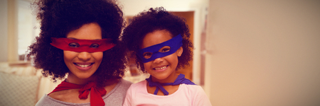 Mother and daughter playing superwoman