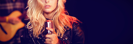 Portrait of female singer with blond hair at concert in nightclubの写真素材