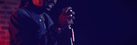 Smiling male singer performing in popular music concert