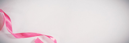Pink ribbon on white background