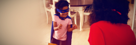 Mother and daughter playing super heroesの写真素材