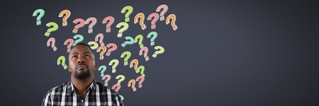 Digital composite of Man with colorful funky question marks emerging from headの写真素材