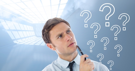 Digital composite of Man thinking with question marksの写真素材