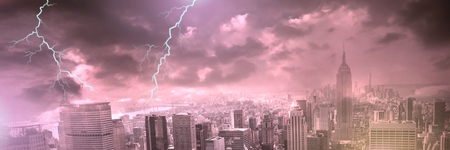 Digital composite of Lightning strikes in sky over cityの写真素材