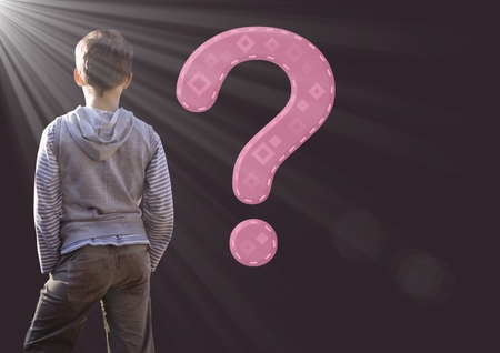 Digital composite of Kid Boy with question mark and light sourceの写真素材