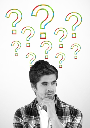 Digital composite of Man thinking with colorful question marksの写真素材