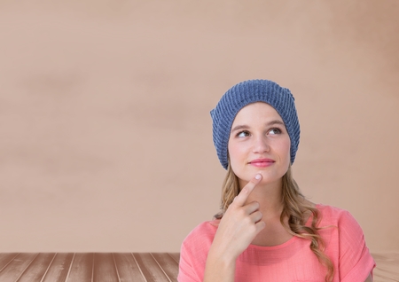 Digital composite of Woman thinking in front of wallの写真素材