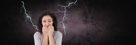 Digital composite of Lightning strikes and scared afraid woman biting nailsの写真素材