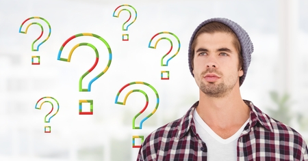 Digital composite of Man thinking with colorful question marksの写真素材