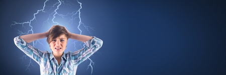 Digital composite of Lightning strikes and stressed woman with headache holding head