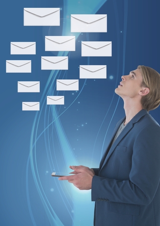 Digital composite of Envelope letter messages and man using phoneの写真素材